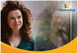 Frau steht vor Fensterfläche rechts oben ist das Logo von KÖMMERLING platziert